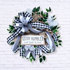 a black and white wreath that says stay humble and have a bird on it