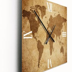 a clock on the wall with a world map in it's center and two hands