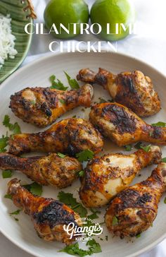 grilled chicken wings with cilantro and limes on the side