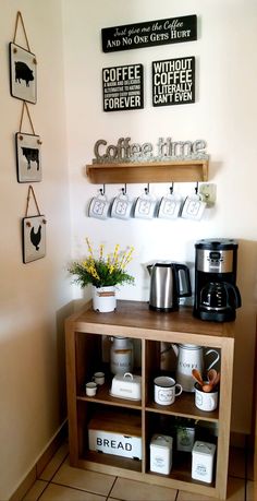 a coffee bar with various items displayed on the wall and shelves above it, along with mugs