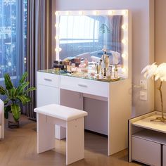 there is a vanity with lights on it and a stool in front of the mirror