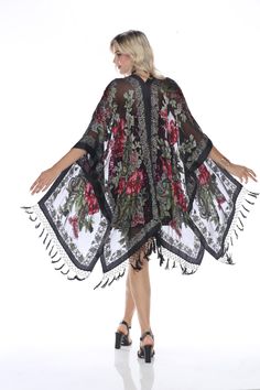 Make a dramatic statement with this sheer black kimono, beautifully adorned with vibrant floral embroidery and intricate border details. The flowing silhouette and delicate fringe accents create a perfect balance of elegance and bohemian charm. Ideal for layering over formal or casual outfits, this kimono is a versatile and stylish wardrobe addition. Evening Shawls And Wraps, Kimono With Fringe, Evening Shawls, Embroidered Kimono, Sheer Kimono, Black Kimono, Womens Jackets, Shawls And Wraps, Floral Embroidery