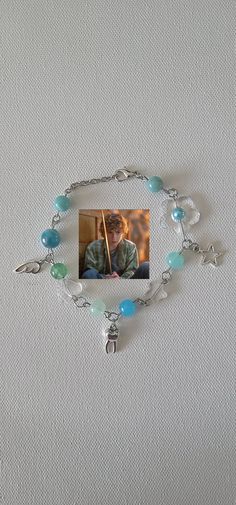 a bracelet with beads and charms attached to it