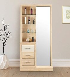 a tall wooden cabinet sitting next to a mirror