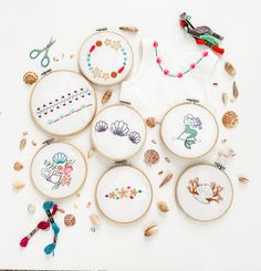 embroidery kits are arranged on a white surface