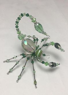 a green spider made out of glass beads