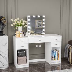 a white vanity with lights on it and a vase full of flowers in front of the mirror