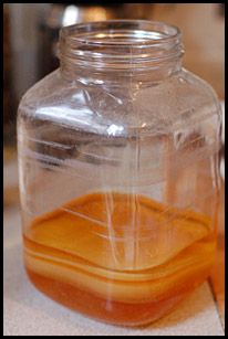 a glass jar filled with liquid sitting on top of a counter