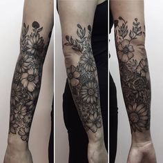 the arm is covered with black and white floral tattoos on both sides of the arms