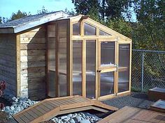 a small wooden building with windows on the roof