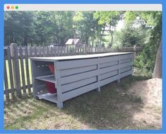 an outdoor storage area in the middle of a yard with trees and fence around it