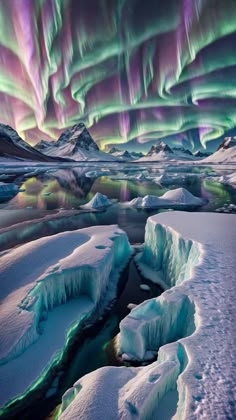 the aurora bore is lit up over an icy landscape