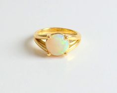 Opal Ring 18k Yellow Gold / Opal Engagement Ring / Gold Opal Ring / Solitaire Opal Ring 18k Gold / Natural Opal / October Birthstone Ring / ALTERNATIVE ENGAGEMENT RING / BRIDAL JEWELRY / OCTOBER BIRTHSTONE FREE SHIPPING WITHIN THE USA THE OPAL I S ALL NATURAL 1.02 CT ROUND 8 MM WIDE MEDIUM SATURATION . THE RING IS 18 KARAT YELLOW GOLD , SIZE 5 BUT I CAN SIZE IT FOR FREE. METAL:18 K YELLOW GOLD 750 STONES: NATURAL 8 MM OPAL STYLE: SOLITAIRE ENGAGEMENT RING PURITY: 18 K , OPAL IS ALL NATURAL SIZE: Simple Gold Wedding Rings, Solitaire Opal Ring, Gold Opal Engagement Ring, Unique Opal Ring, Gold Opal Ring, October Birthstone Ring, Diamond Star Necklace, Engagement Ring Gold, Opal Solitaire Ring