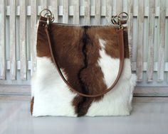 "HANDMADE COW HIDE Hair Bag Handbag Brown White Hair on Hide Zipper On Top Large Leather Shoulder Bag Women Large Capacity Bag Gift For Her COWHIDE HAIR On HANDBAGS, Unique Bags and Purses, Shoulder Bag in Brown White Hide Hair,Tote Leather Purse with Zipper On Top, Birthday Gift BROWN WHITE COWHIDE Tote Bag in Gorgeous Calf Hair, Cowhide Hair Shoulder Bag, Brown Weekend Tote, Brown Cowhide Bag, Pony Hair Bag, Texas.  each piece is one of a kind and forever unique.  We hand pick each hide ourselves, selecting only the best pieces for our bags, pre planning the best position to capture the best motif on each hide.  For those of us that love hide hair and leather, this bag showcases, the beauty of the hide hair mid center.  Fill it with everything you need, surprisingly spacious, is your all Brown White Hair, Handbags Unique, Slouch Bag, Hair Bag, Cowhide Purse, Bags 2024, Slouch Bags, Cowhide Bag, Brown Cowhide