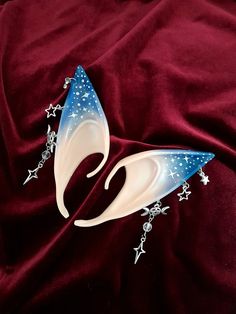 These handmade blue celestial star elf ears are the perfect cherry on top for any cosplay, renfaire, dnd, or larp outfit! package includes 1 pair of elf ears ears elf ear care: - DO NOT forcefully bend your elf ears, they are made to be slipped onto the ear - don't store your ears on any jagged surfaces as this may scratch the paint - don't leave your ears sitting in extreme temperatures Celestial Elf Costume, Moon Elf Cosplay, Elf Ears Jewelry, Elf Ears With Piercings, Renfaire Accessories, Cosplay Elf Ears, Star Elf, Larp Outfit, Cosplay Elf