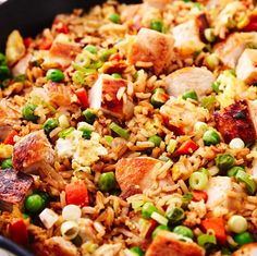 a skillet filled with rice, meat and vegetables