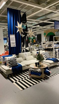 a living room filled with lots of furniture and decor on top of a carpeted floor