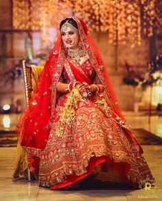 a woman in a red and gold bridal gown