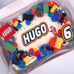 a birthday cake with legos on it in a plastic container for someone's 6th birthday