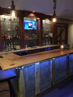 a bar with wooden shelves and blue lights