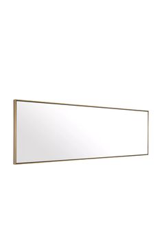 a large mirror mounted to the side of a wall next to a white wall behind it