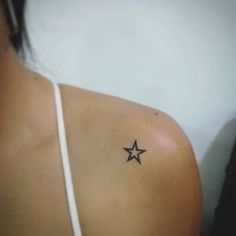 a woman with a small star tattoo on her shoulder