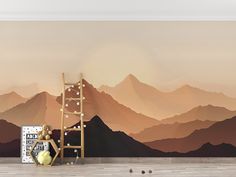 a room with mountains painted on the wall and a ladder leaning up against the wall