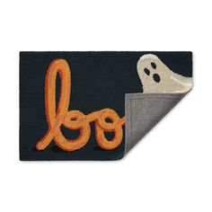 a door mat with the word boo on it and a ghost coming out of it