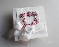 a heart shaped card with pink flowers on it