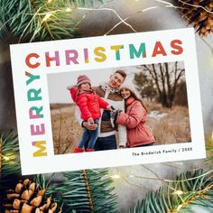 a merry christmas card with an image of two people and pine cones on the background