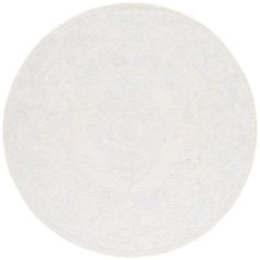 a white round rug with an intricate design