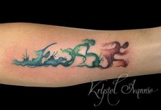 an arm with some watercolors on it and the word love written in cursive