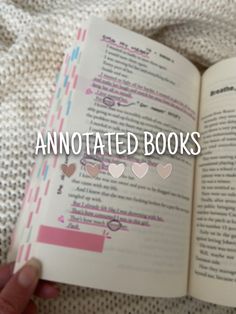 an open book with the words annotated books written in pink and white on it