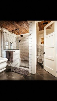 a bathroom with a shower, toilet and sink in it's center piece is shown