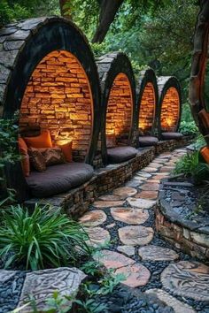 an outdoor seating area with stone walls and benches in the middle, surrounded by greenery