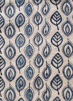 a blue and white fabric with small leaves on the side, which are drawn in black ink