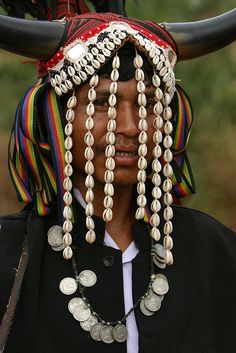 a man with horns and beads on his head