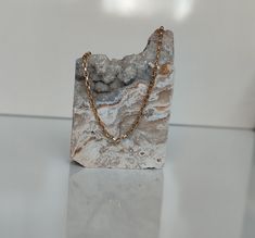 a rock with a chain on it sitting on a table