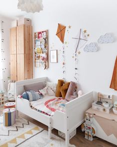 a child's bedroom decorated in white and wood