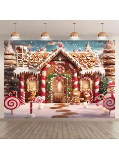 a christmas scene with gingerbread houses and candy canes on the floor in front of a large wall mural