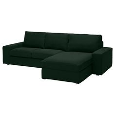 a black couch sitting on top of a white floor