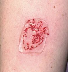 a close up of a person's arm with a strawberry on the back of it