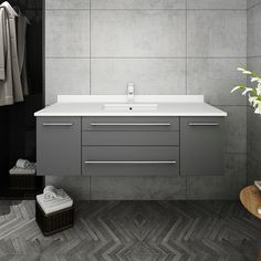 a bathroom with a sink, mirror and towel rack in it's center area