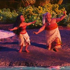 two women dressed in native garb dancing together