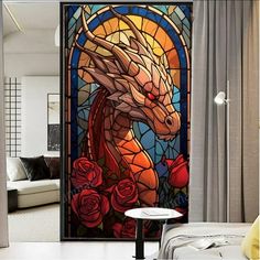 a room with a large stained glass window and a dragon on the wall next to it