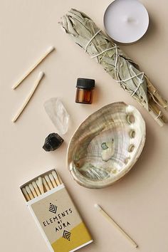 an assortment of essentials including incense sticks, matches and other items on a table