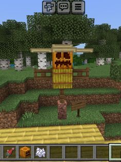 a screenshot of a minecraft village in the middle of a field with trees and bushes