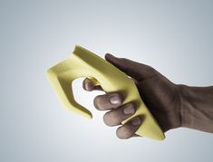 a person's hand holding a yellow sponge