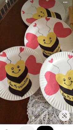 four paper plates with hearts and bees on them