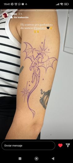 a woman's arm with a dragon tattoo on the left side of her arm